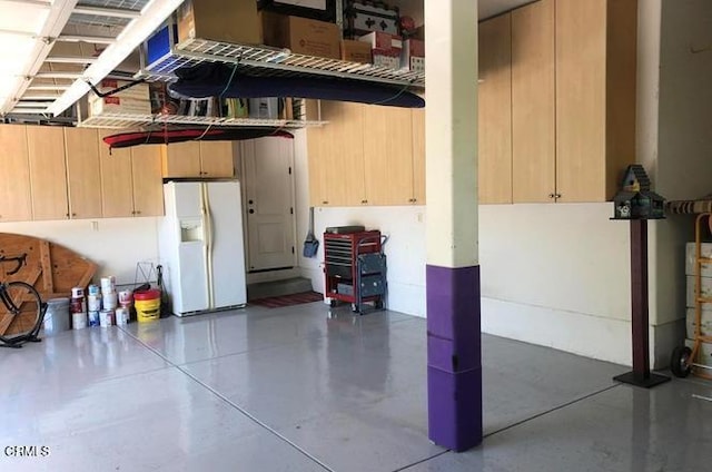 garage with white fridge with ice dispenser