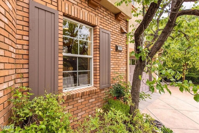 view of side of home with brick siding