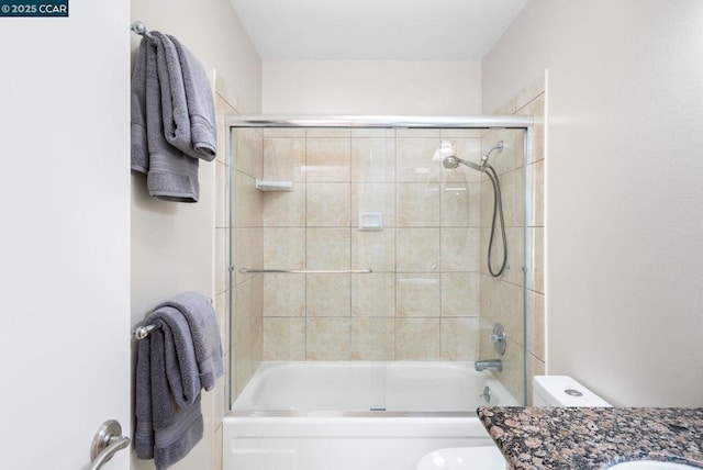 full bathroom featuring vanity, toilet, and enclosed tub / shower combo