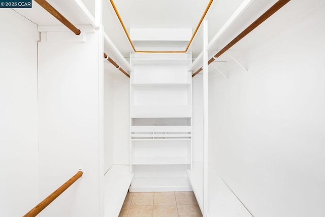 walk in closet with light tile patterned floors