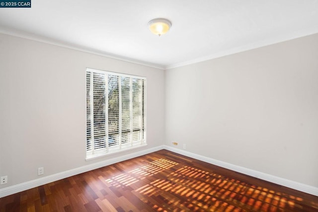 spare room featuring hardwood / wood-style floors and ornamental molding