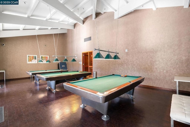 game room with beamed ceiling, a high ceiling, and billiards