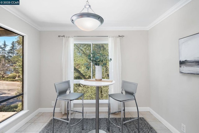 tiled dining area with a wealth of natural light and ornamental molding