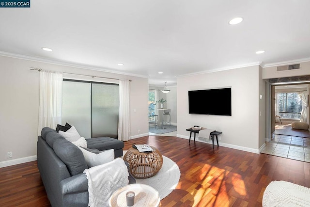 living room with dark hardwood / wood-style flooring, a wealth of natural light, and ornamental molding