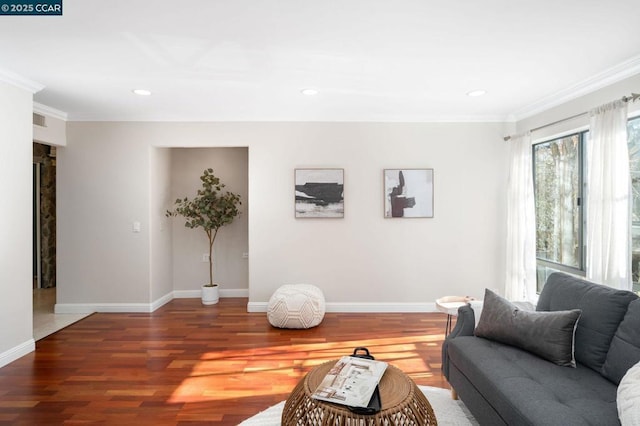 living room featuring wood-type flooring and crown molding