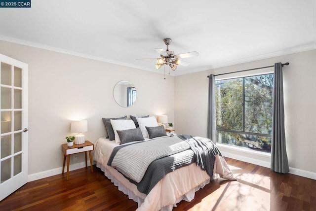 bedroom featuring dark hardwood / wood-style floors, ceiling fan, and ornamental molding