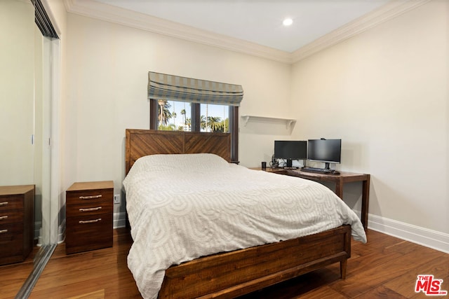 bedroom with dark hardwood / wood-style flooring and ornamental molding