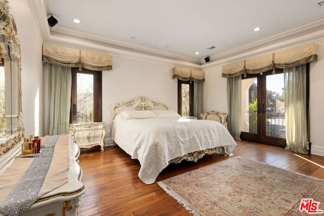 bedroom with french doors, access to outside, dark hardwood / wood-style floors, and ornamental molding