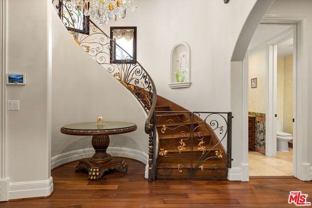 stairway with hardwood / wood-style floors