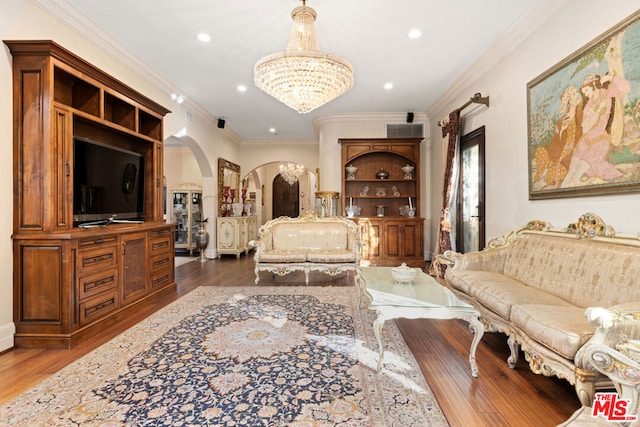 bedroom with dark hardwood / wood-style floors, crown molding, and a chandelier