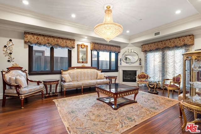 living room with ornamental molding, dark wood-type flooring, and a chandelier