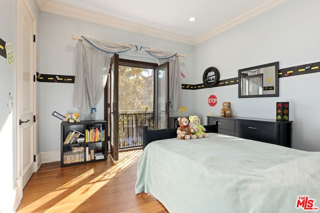 bedroom featuring hardwood / wood-style floors, access to outside, and ornamental molding