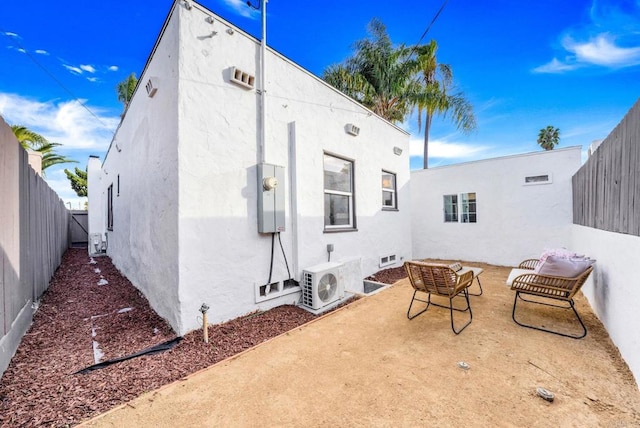 back of property with a patio area and ac unit