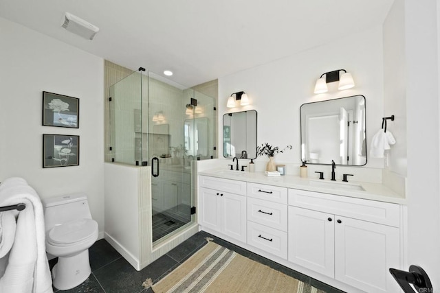 bathroom featuring vanity, a shower with shower door, tile patterned floors, and toilet