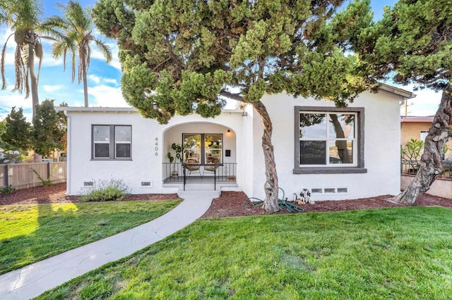 mediterranean / spanish-style home with covered porch and a front yard