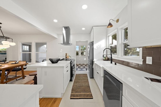 kitchen featuring pendant lighting, backsplash, white cabinetry, exhaust hood, and stainless steel appliances