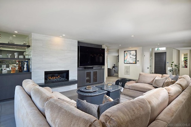 living room with a tiled fireplace