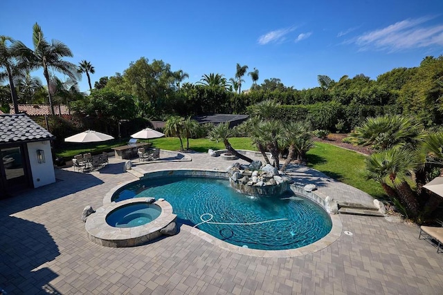 view of swimming pool with an in ground hot tub, a patio, and a lawn