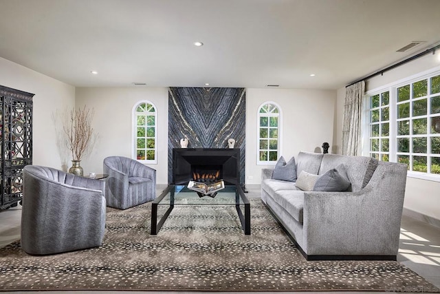 living room with a large fireplace and a wealth of natural light