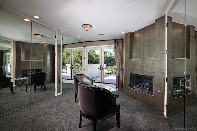 carpeted living room with french doors and a tiled fireplace