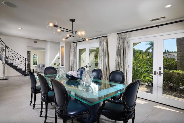 dining room featuring french doors and an inviting chandelier