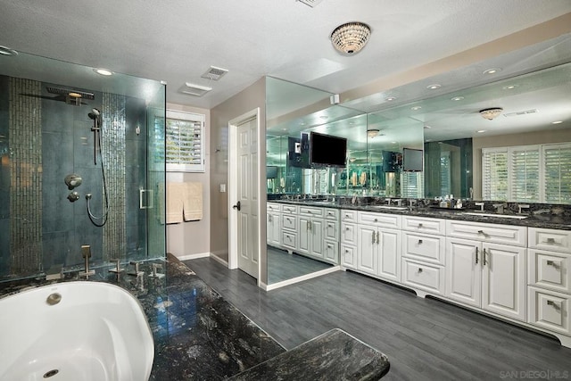 bathroom featuring vanity, plus walk in shower, and hardwood / wood-style flooring