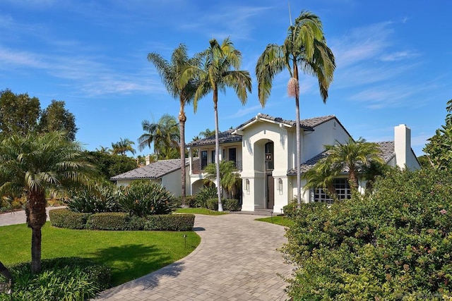 mediterranean / spanish house featuring a front lawn