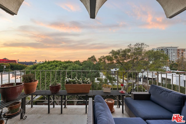 balcony at dusk with an outdoor hangout area