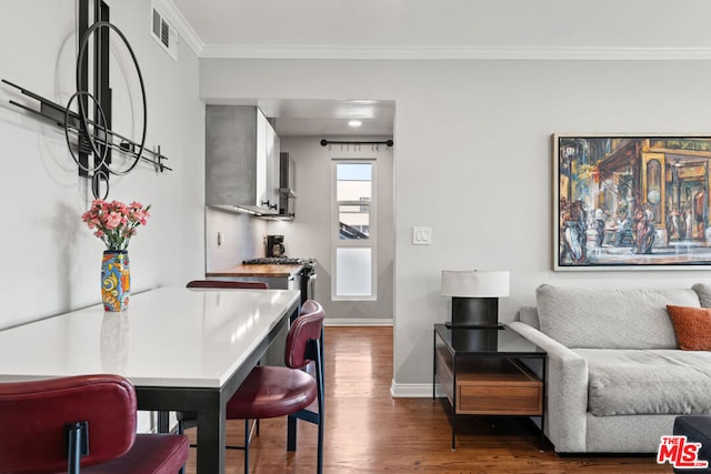 interior space featuring dark hardwood / wood-style flooring and ornamental molding