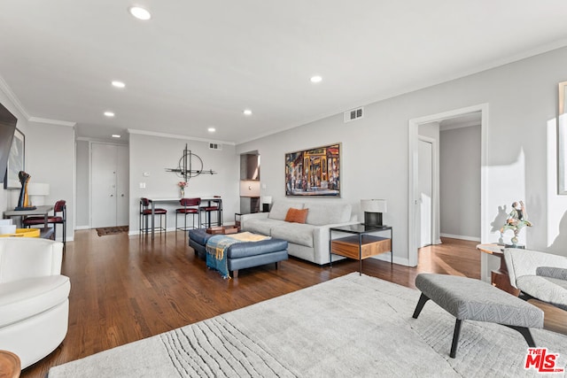 living room featuring crown molding and wood-type flooring