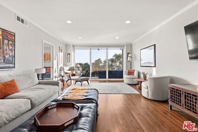 living room featuring wood-type flooring and ornamental molding