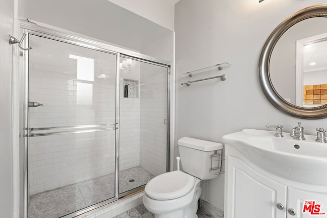 bathroom featuring an enclosed shower, vanity, and toilet