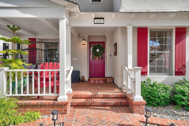 view of exterior entry featuring a porch