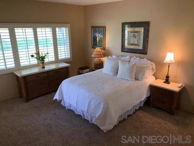 bedroom with dark colored carpet