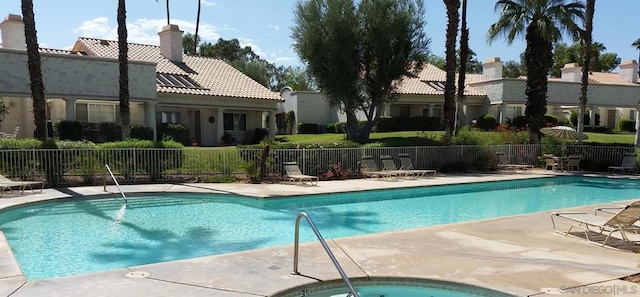 view of swimming pool with a community hot tub and a patio