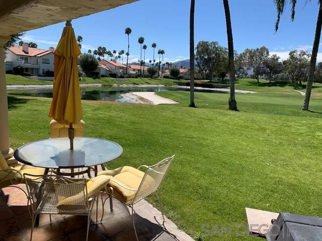 view of community with a water view and a yard