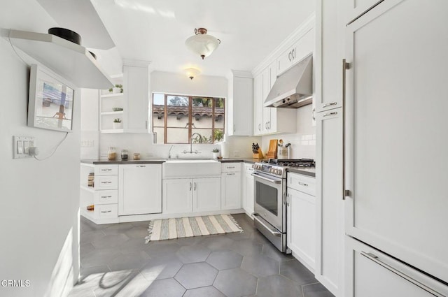 kitchen featuring dishwasher, sink, tasteful backsplash, high end range, and white cabinets