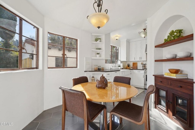 tiled dining area featuring sink