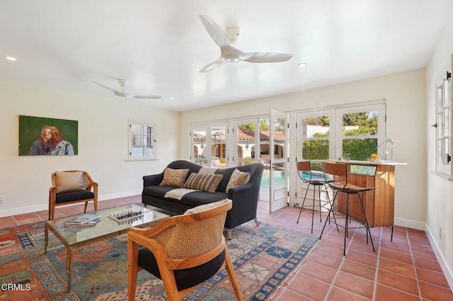 tiled living room with french doors and ceiling fan