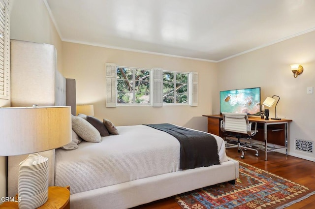 bedroom with crown molding and dark wood-type flooring