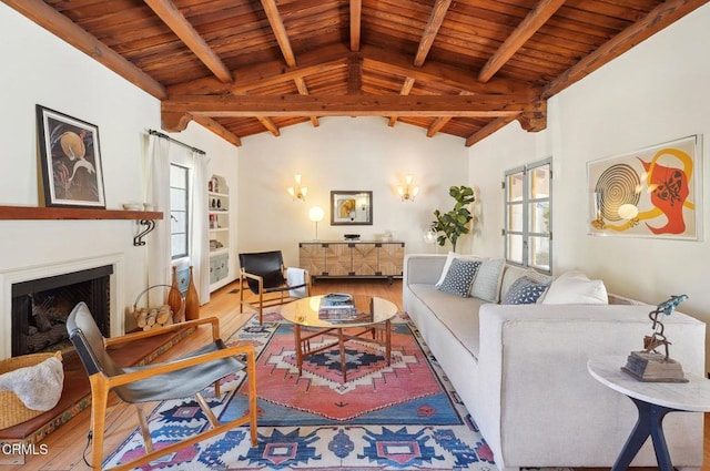 living room featuring vaulted ceiling with beams, wood-type flooring, and wooden ceiling