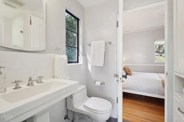 bathroom featuring sink, toilet, and hardwood / wood-style flooring