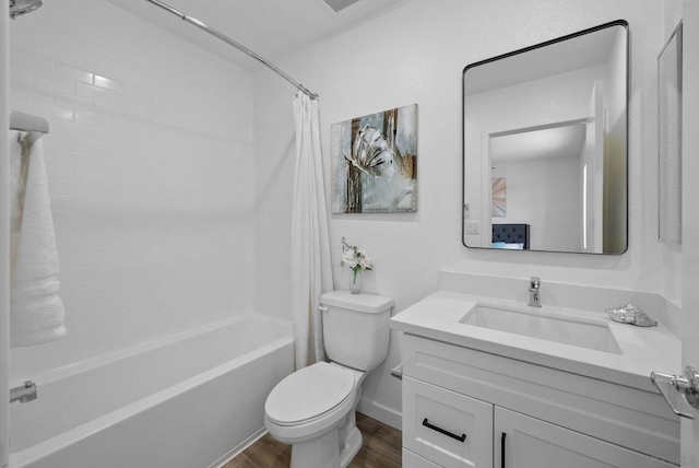 full bathroom featuring shower / bath combo with shower curtain, vanity, hardwood / wood-style floors, and toilet