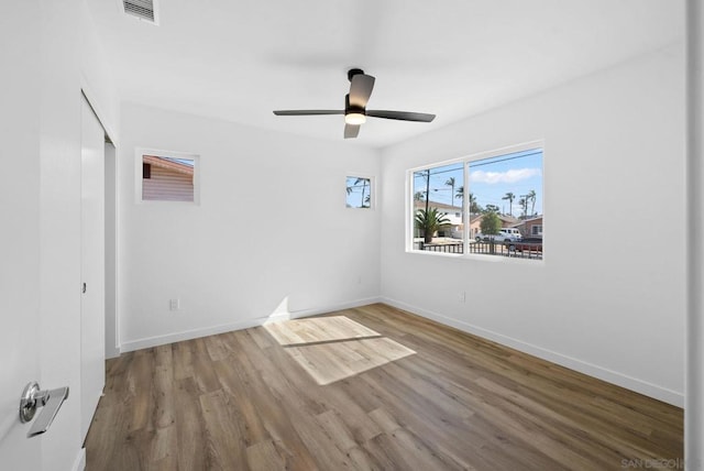 unfurnished room with ceiling fan and wood-type flooring