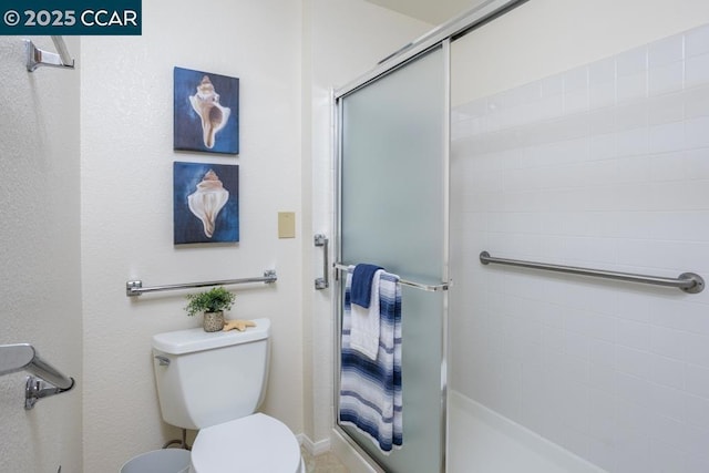 bathroom with an enclosed shower and toilet