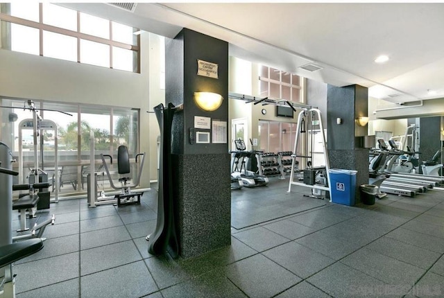 workout area featuring a towering ceiling