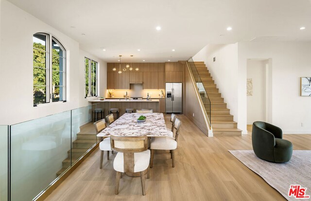 dining space with light hardwood / wood-style floors