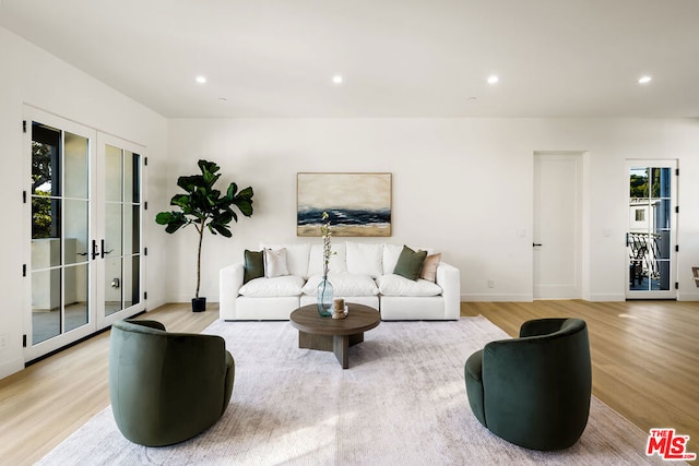 living room featuring french doors and light hardwood / wood-style floors