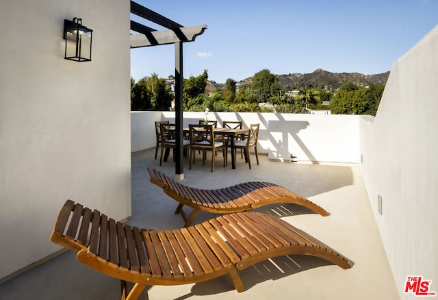 view of patio featuring a mountain view and a pergola