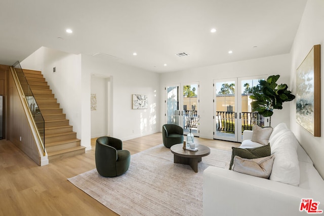 living room with french doors and light wood-type flooring